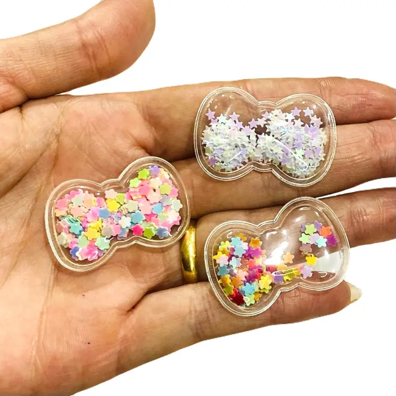Aplique em Plástico transparente LACINHO LANTEJOULAS COLORIDO Altura de 2,5cm x 3,5cm - Lacinho Glitter Branco
